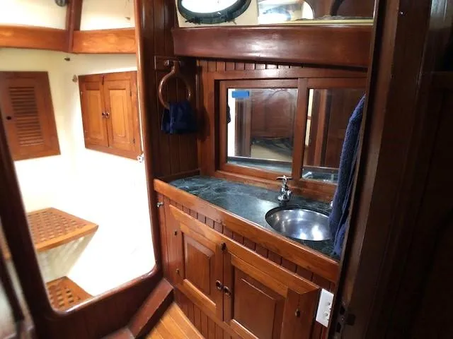 Slide: The Image of 1979 Hans Christian 38 MKII yacht interior with wooden cabinetry and sink. - 18