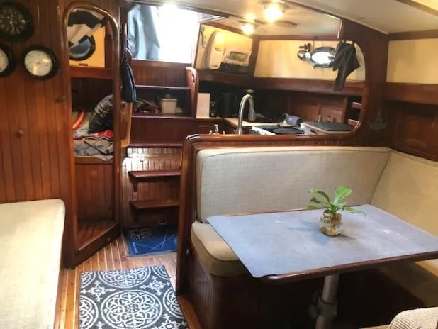 Slide: The Image of Interior of 1979 Hans Christian 38 MKII sailboat with cozy seating and wooden finishes. - 22