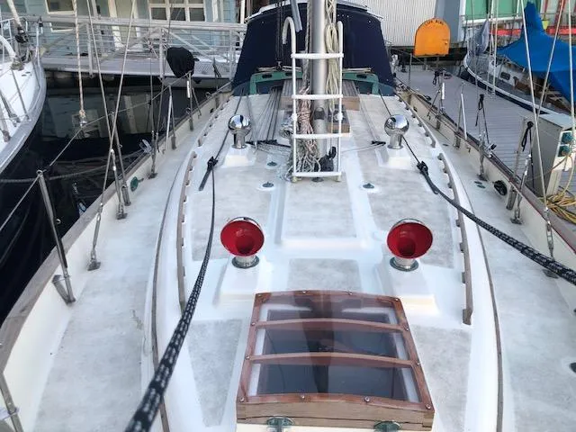 Slide: The Image of 1979 Hans Christian 38 MKII sailboat deck with red lights and wooden hatch. - 3
