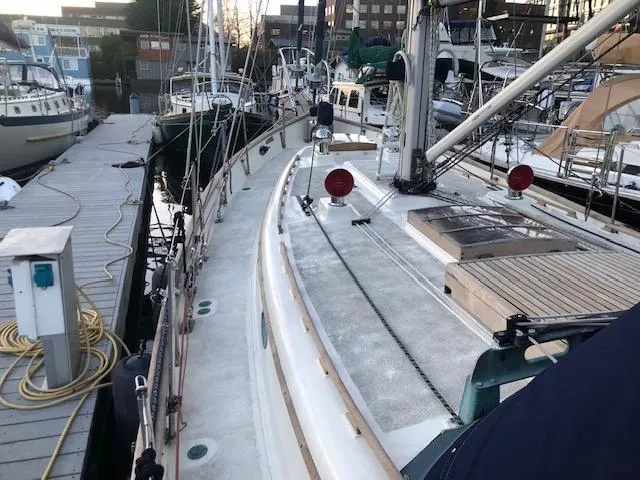 Slide: The Image of 1979 Hans Christian 38 MKII sailboat docked at a marina, showcasing deck and rigging. - 5