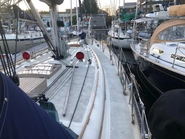 Slide: The Image of 1979 Hans Christian 38 MKII sailboat docked among other boats at a marina. - 6