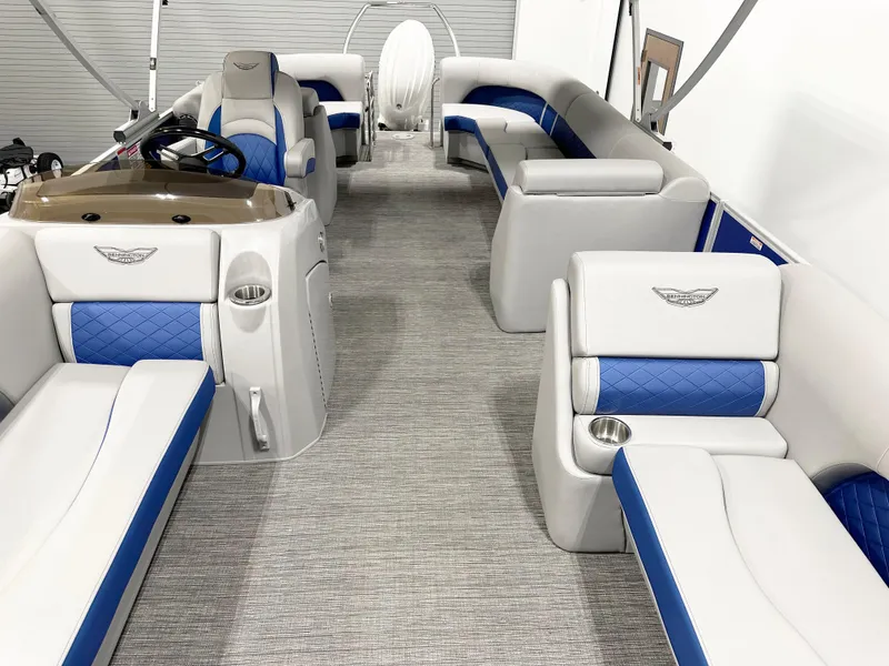 Slide: The Image of 2025 Bennington 23LFBCSR pontoon boat interior with blue and white seating. - 10