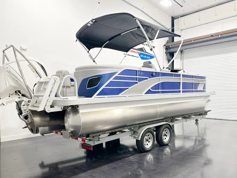 Slide: The Image of 2025 Bennington 23LFBCSR pontoon boat on trailer in indoor showroom. - 3