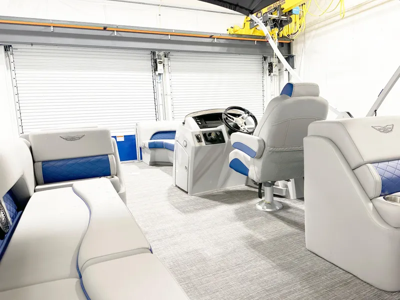 Slide: The Image of 2025 Bennington 23LFBCSR pontoon boat interior with plush seating and modern helm. - 7