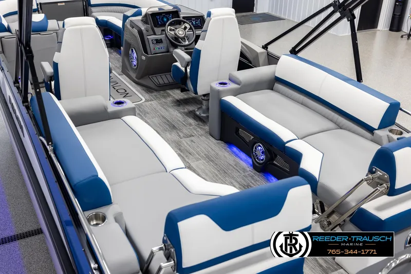 Slide: The Image of 2025 Avalon Catalina QLS boat interior with blue and white seating, modern dashboard, and ambient lighting. - 11