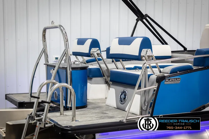 Slide: The Image of 2025 Avalon Catalina QLS boat with blue and white seating, ladder, and sleek design. - 42