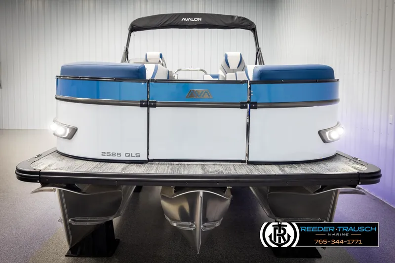 Slide: The Image of 2025 Avalon Catalina QLS pontoon boat, blue and white design, displayed indoors. - 8