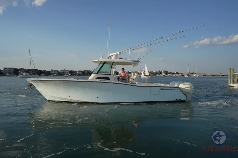 Slide: The Image of 2024 Grady-White Canyon 336 boat cruising on calm waters under a clear sky. - 11