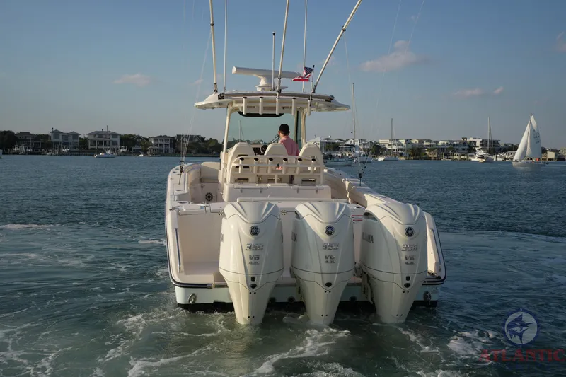 Slide: The Image of 2024 Grady-White Canyon 336 boat with triple outboard engines on the water. - 15