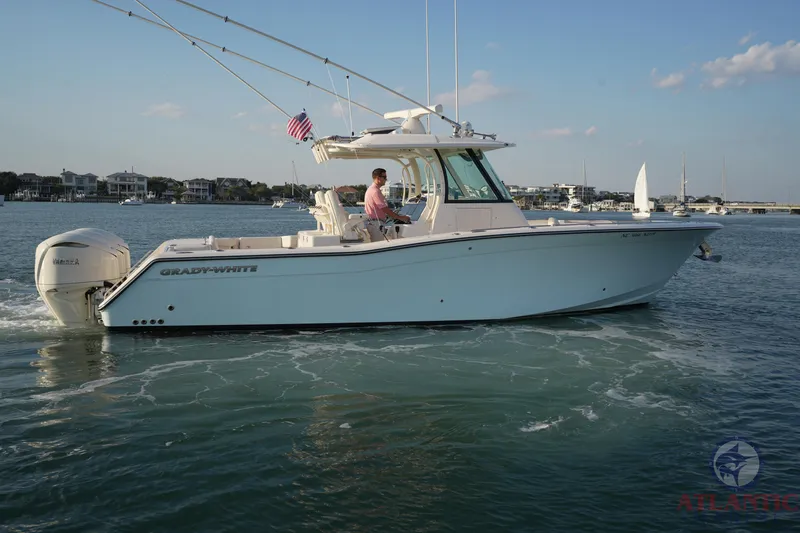 Slide: The Image of 2024 Grady-White Canyon 336 boat cruising on a calm waterway. - 20