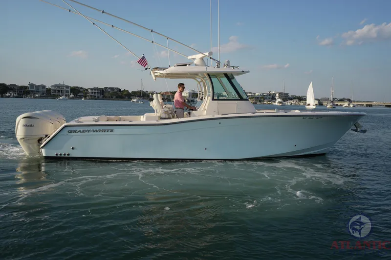 Slide: The Image of 2024 Grady-White Canyon 336 boat cruising on calm waters with clear skies. - 21