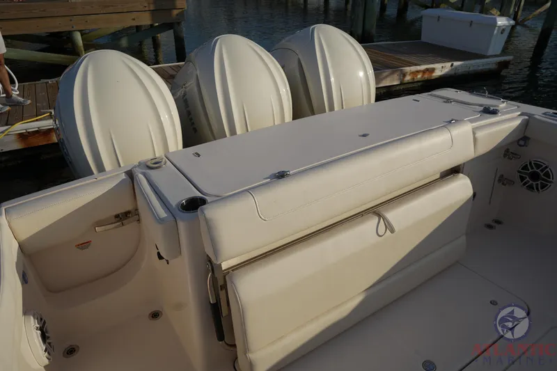 Slide: The Image of 2024 Grady-White Canyon 336 boat interior with triple outboard engines at dock. - 23
