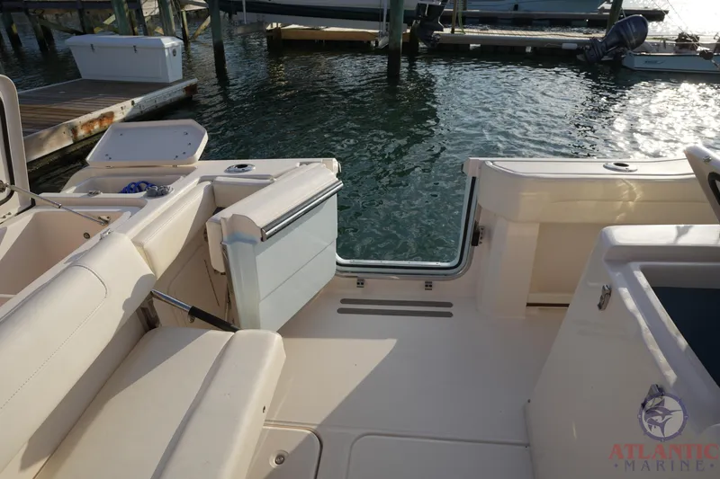 Slide: The Image of 2024 Grady-White Canyon 336 boat interior with open deck and seating by the water. - 26