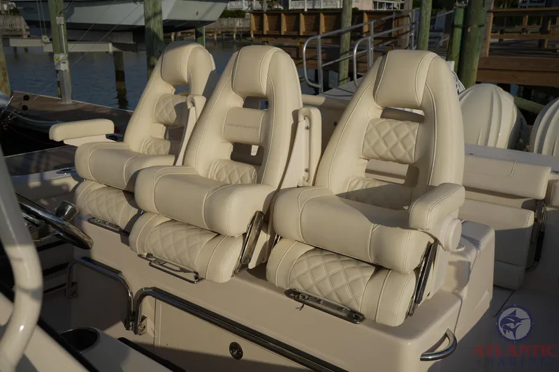 Slide: The Image of 2024 Grady-White Canyon 336 boat seats, luxurious white leather, docked at marina. - 29
