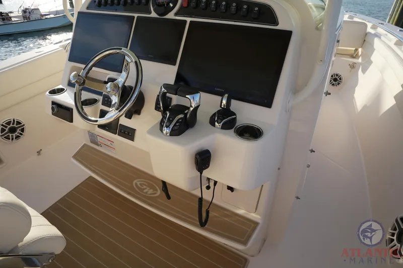 Slide: The Image of 2024 Grady-White Canyon 336 helm with dual screens and modern controls. - 31