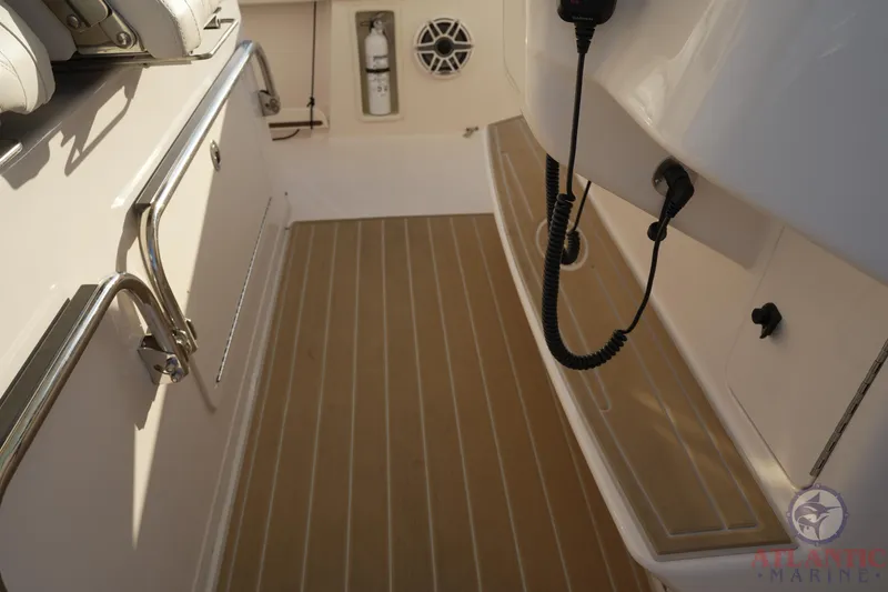 Slide: The Image of 2024 Grady-White Canyon 336 boat deck with teak flooring and marine equipment. - 32