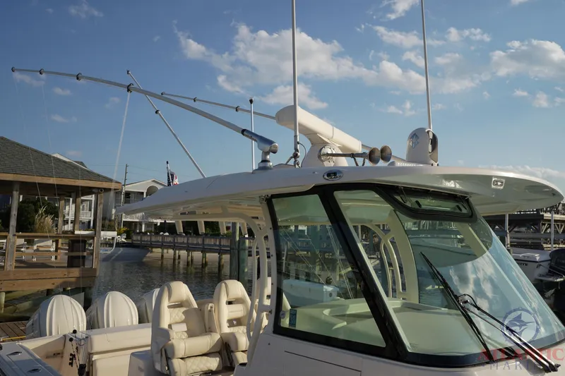 Slide: The Image of 2024 Grady-White Canyon 336 boat docked under a clear blue sky. - 34