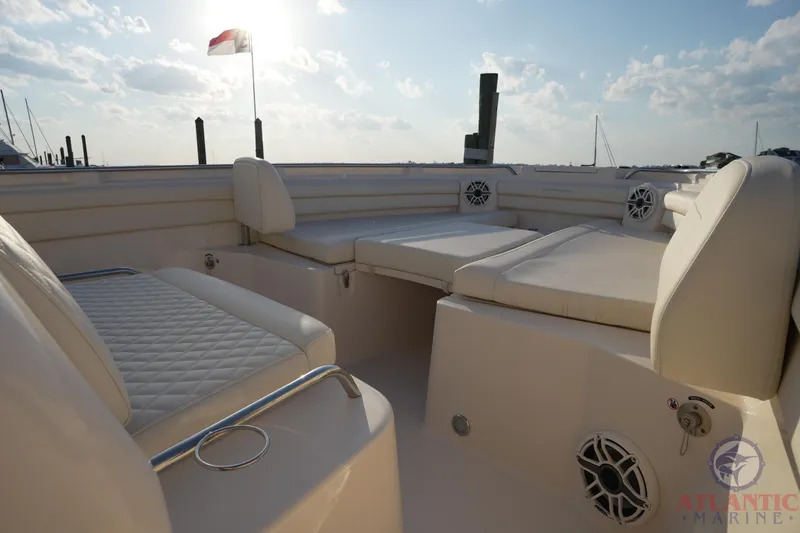 Slide: The Image of 2024 Grady-White Canyon 336 boat interior with cushioned seating and marine speakers. - 37