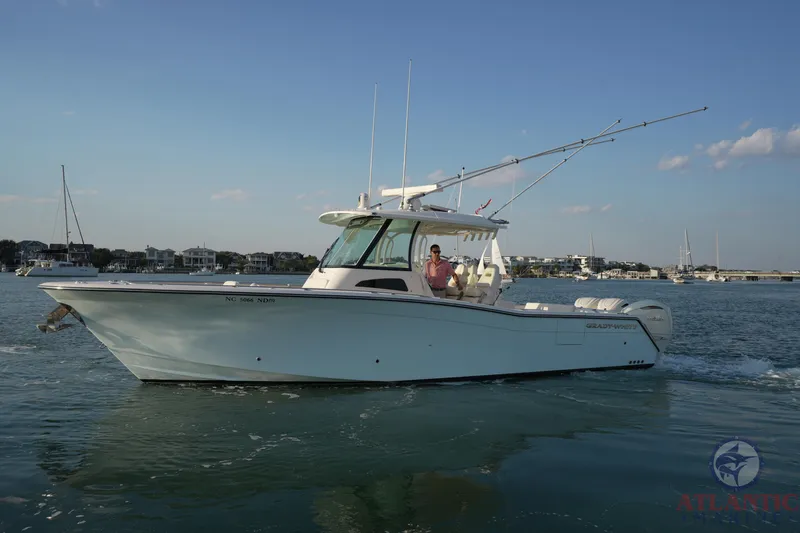 Slide: The Image of 2024 Grady-White Canyon 336 boat cruising on calm waters under a clear sky. - 8