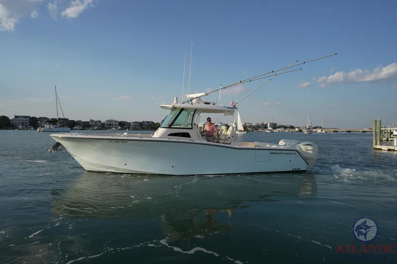 Slide: The Image of 2024 Grady-White Canyon 336 boat cruising on calm waters under a clear sky. - 9