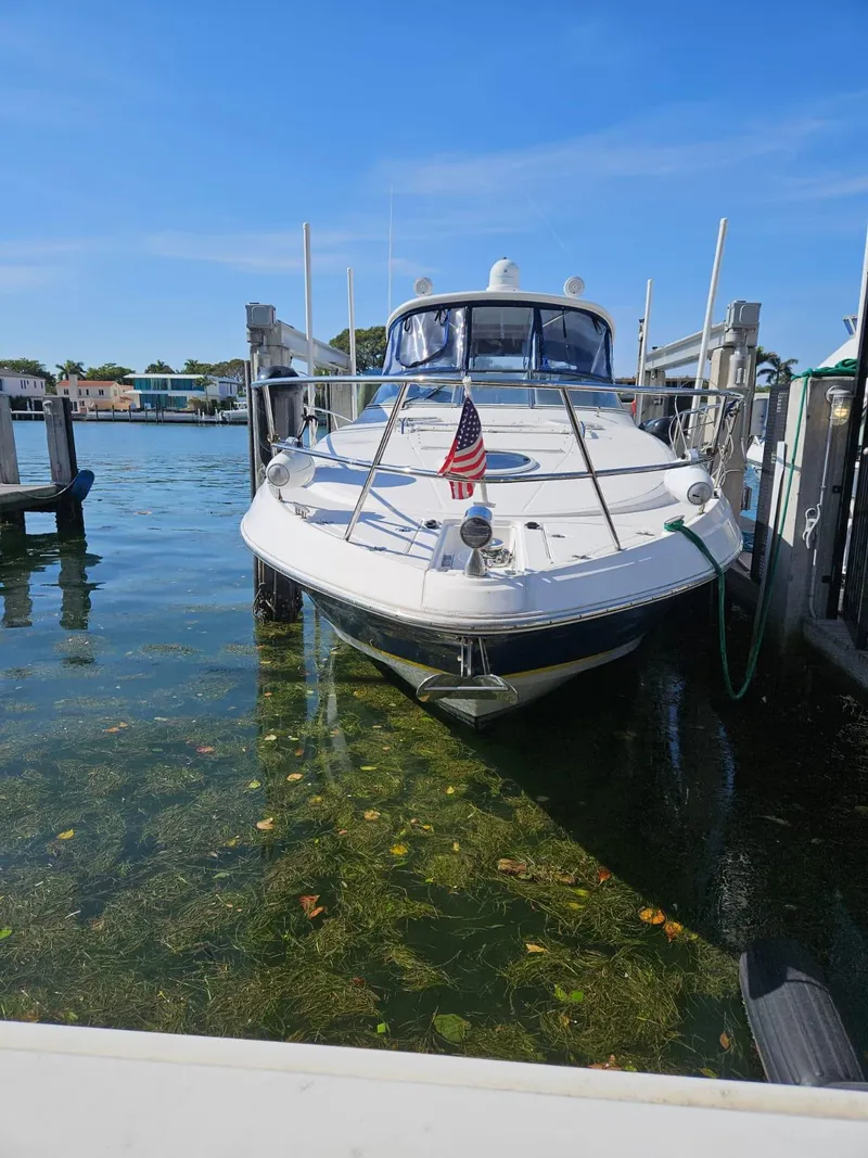 Slide: The Image of 2007 Regal 3760 Sportyacht docked in clear water with American flag. - 13