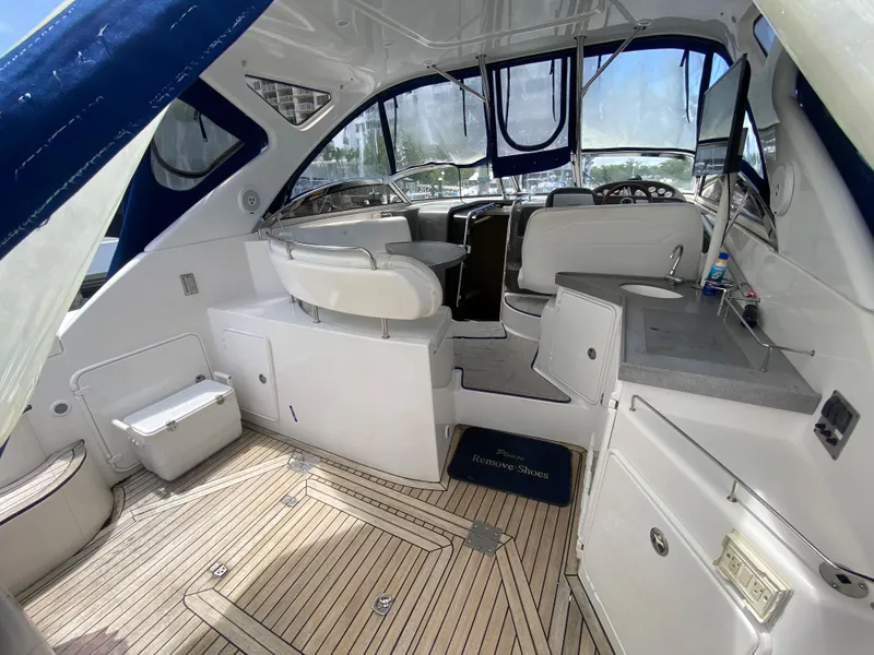 Slide: The Image of 2007 Regal 3760 Sportyacht interior with seating, kitchenette, and wooden flooring. - 18