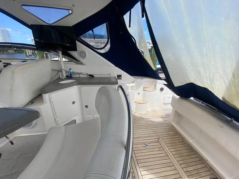 Slide: The Image of Interior of 2007 Regal 3760 Sportyacht with white seating and wooden flooring. - 19