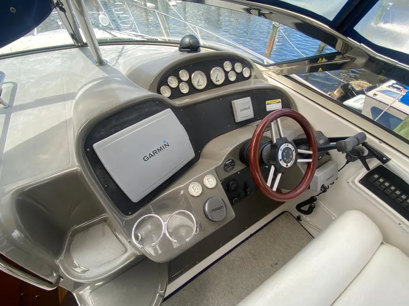 Slide: The Image of 2007 Regal 3760 Sportyacht helm with Garmin navigation, steering wheel, and instrument panel. - 24