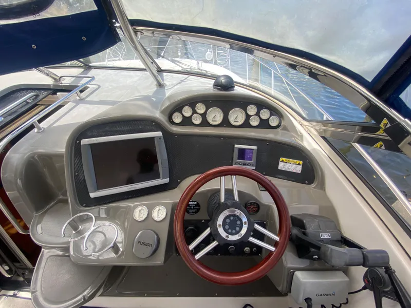 Slide: The Image of 2007 Regal 3760 Sportyacht helm with steering wheel, gauges, and navigation equipment. - 27