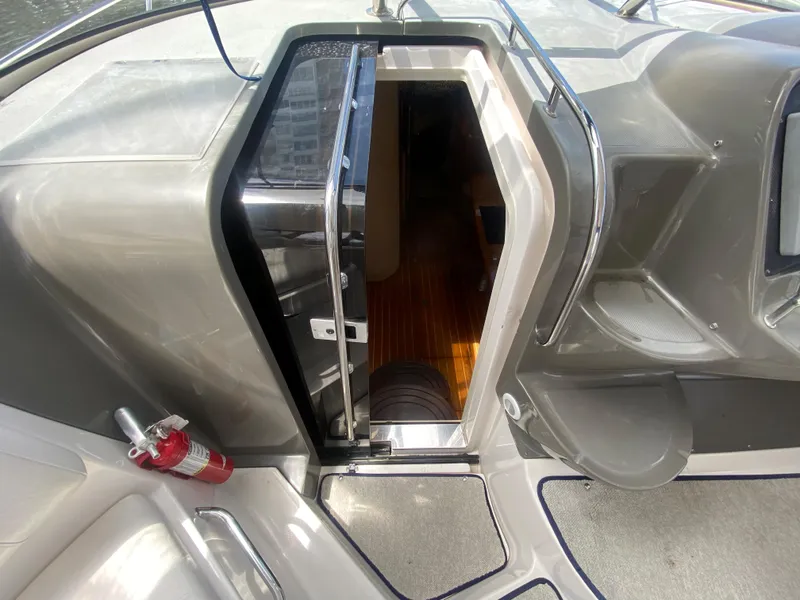 Slide: The Image of 2007 Regal 3760 Sportyacht cabin entrance with fire extinguisher and sleek interior design. - 28