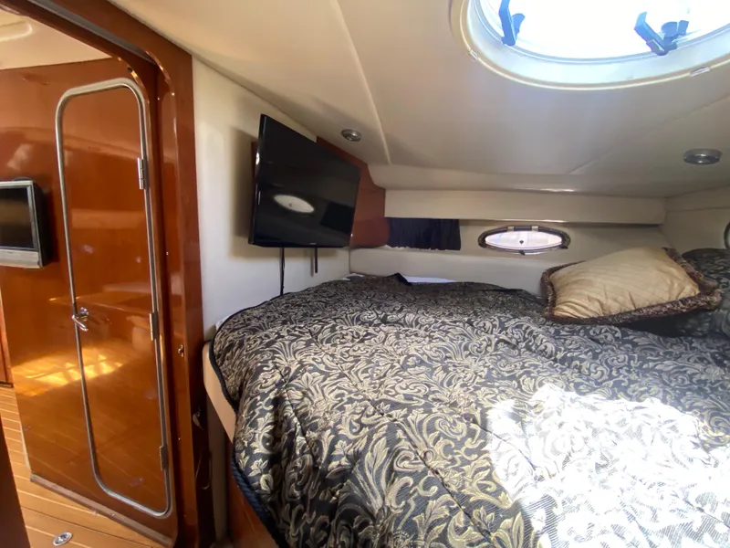 Slide: The Image of Luxurious 2007 Regal 3760 Sportyacht cabin with cozy bed and TV. - 42
