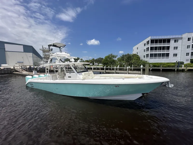 The Image of 2017 Everglades 435 Center Console boat docked in marina under clear blue sky. - 0