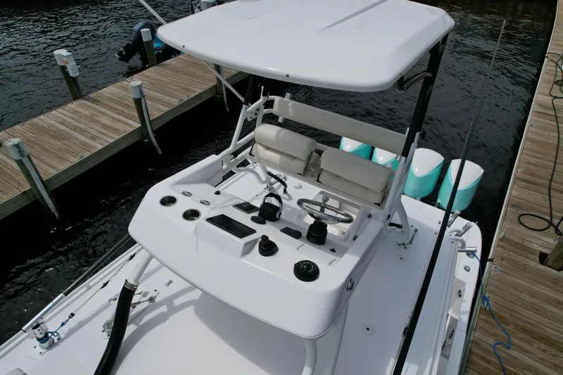 Slide: The Image of 2017 Everglades 435 Center Console boat at dock, featuring helm and seating area. - 14