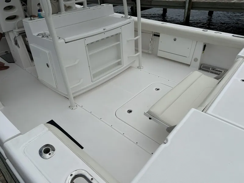 Slide: The Image of 2017 Everglades 435 Center Console boat interior with seating and storage compartments. - 15
