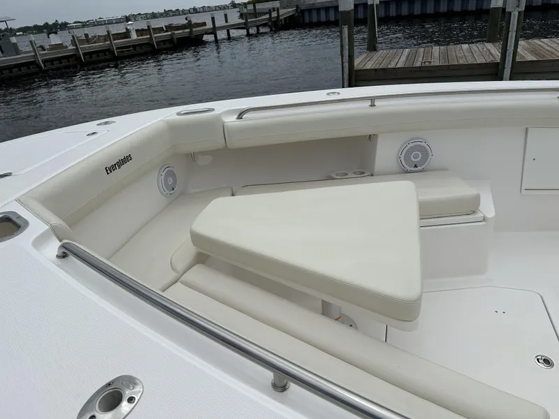 Slide: The Image of 2017 Everglades 435 Center Console boat with white seating, docked by the water. - 17