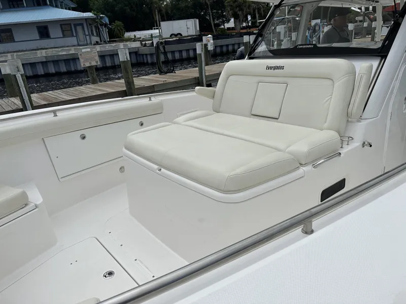 Slide: The Image of 2017 Everglades 435 Center Console boat with white cushioned seating at the dock. - 18