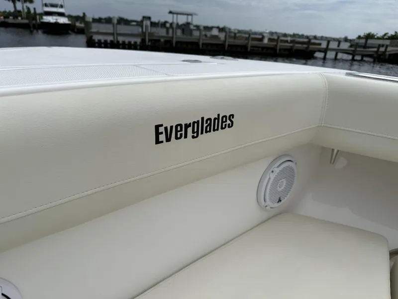 Slide: The Image of 2017 Everglades 435 Center Console boat interior with logo and speaker, dockside view. - 24