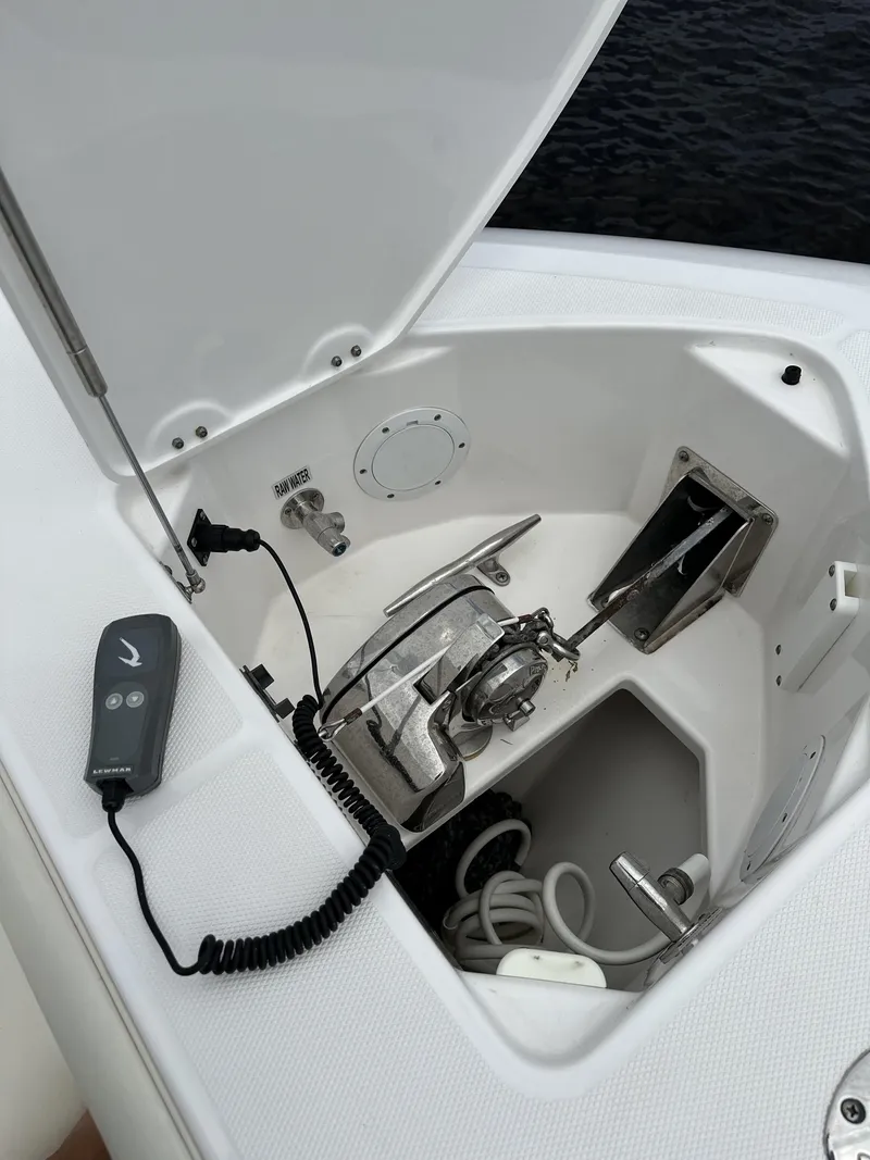 Slide: The Image of 2017 Everglades 435 Center Console anchor compartment with winch and remote control. - 26