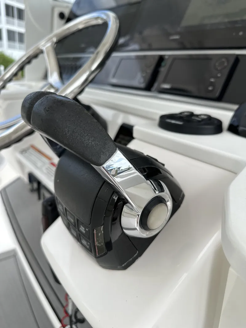 Slide: The Image of Close-up of 2017 Everglades 435 Center Console boat throttle controls. - 35