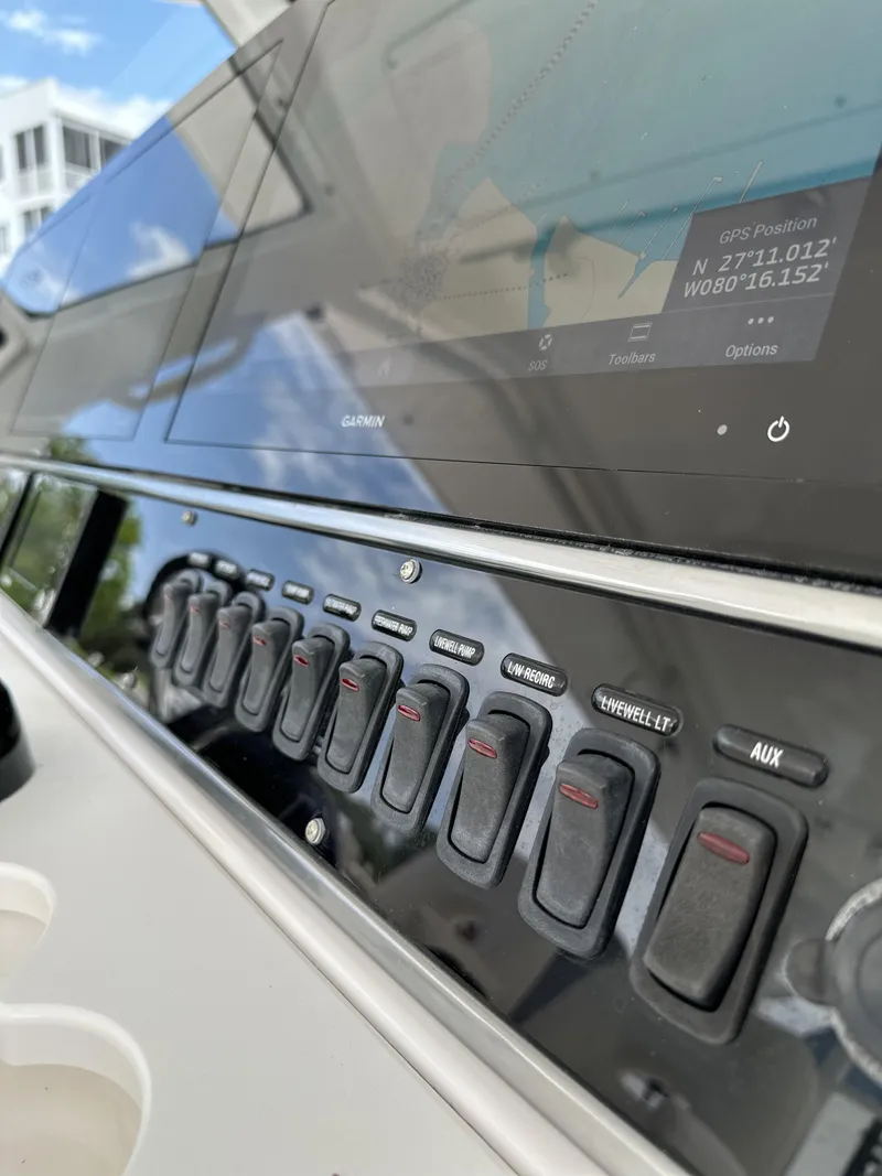 Slide: The Image of Control panel of 2017 Everglades 435 Center Console boat with switches and display. - 38
