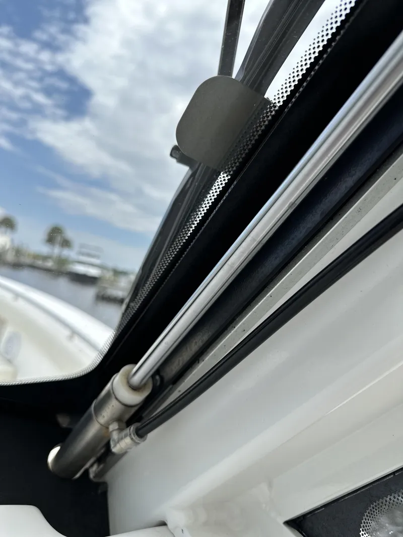Slide: The Image of Close-up of 2017 Everglades 435 Center Console boat window and hydraulic support. - 44
