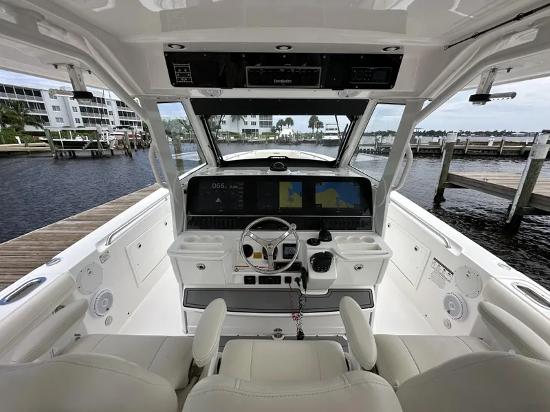 Slide: The Image of 2017 Everglades 435 Center Console boat interior with advanced navigation system at marina. - 46