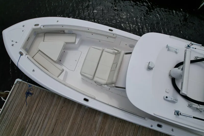 Slide: The Image of 2017 Everglades 435 Center Console boat docked, aerial view showing spacious seating and deck layout. - 6