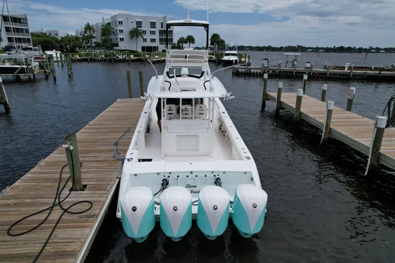 Slide: The Image of 2017 Everglades 435 Center Console boat docked at marina with four engines. - 8