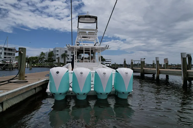 Slide: The Image of 2017 Everglades 435 Center Console boat docked with four outboard engines. - 9
