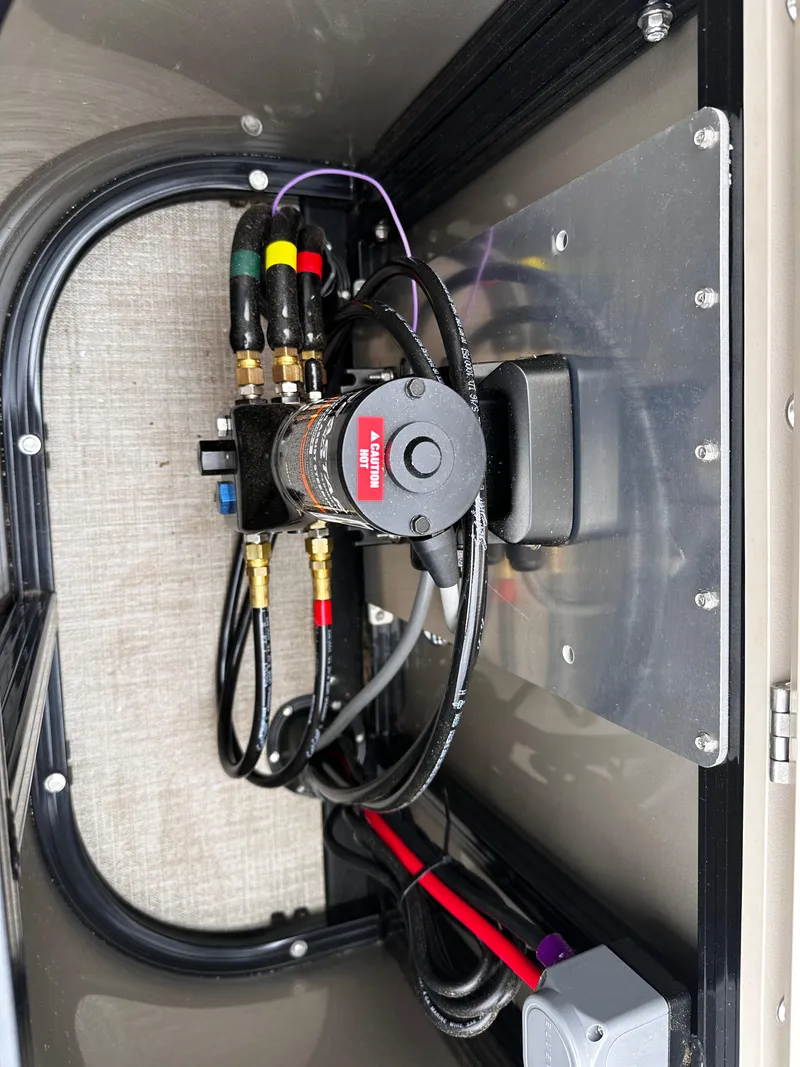 Slide: The Image of 2025 Avalon 2385 LSZ Quad Lounger engine compartment with wiring and components. - 16