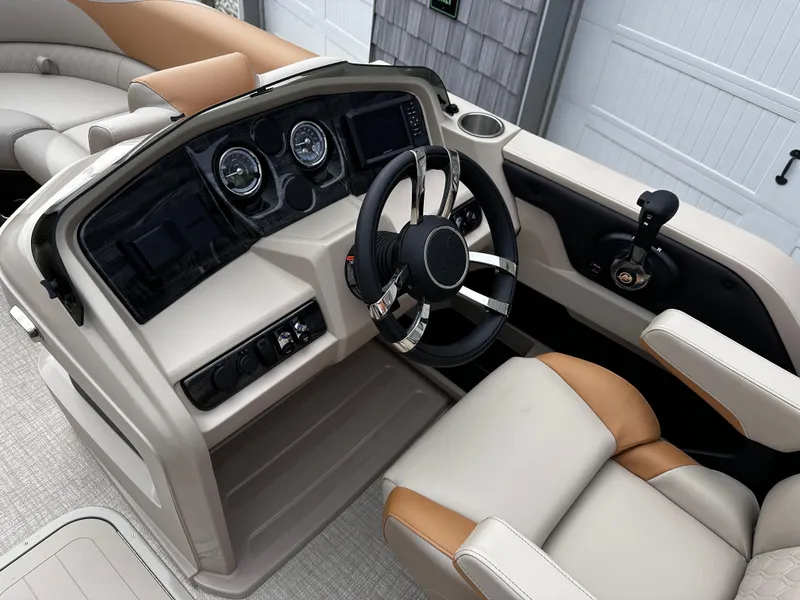 Slide: The Image of 2025 Avalon 2385 LSZ Quad Lounger boat interior with modern steering and controls. - 17