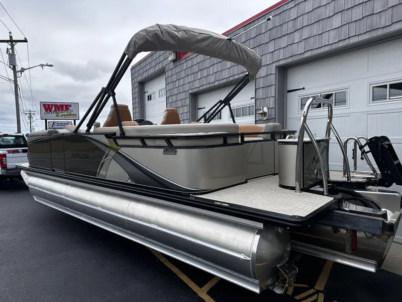 Slide: The Image of 2025 Avalon 2385 LSZ Quad Lounger Tri Toon boat, high performance, parked outside dealership. - 4