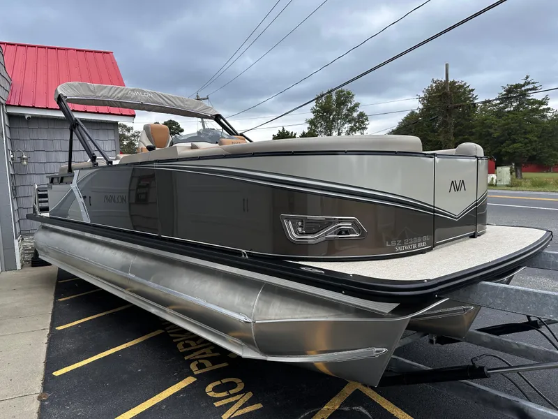 Slide: The Image of 2025 Avalon 2385 LSZ Quad Lounger Tri Toon boat, high performance, parked outdoors. - 6