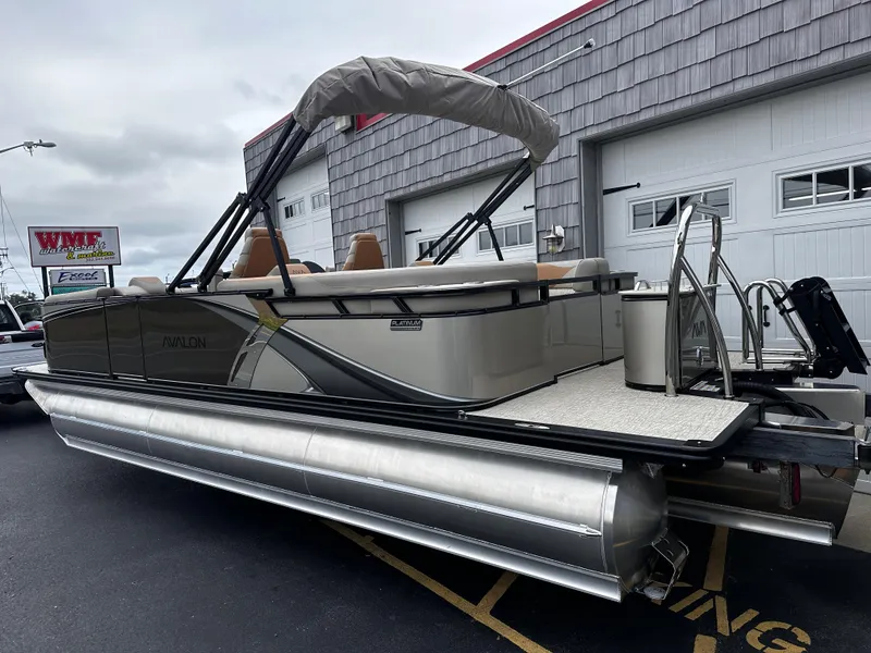 Slide: The Image of 2025 Avalon 2385 LSZ Quad Lounger Tri Toon boat, high performance, parked outdoors. - 8